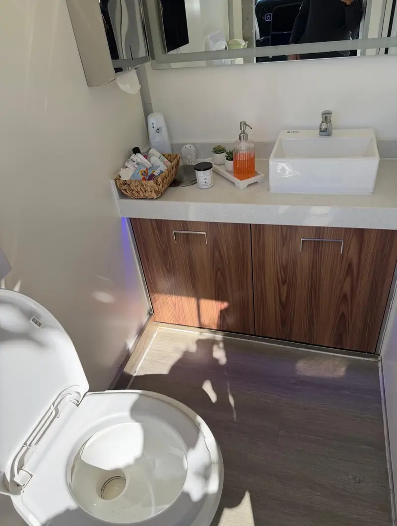 Restroom trailer vanity counter with vessel sink inside a wedding bathroom trailer