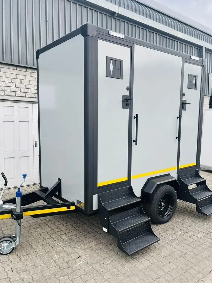 Two-station restroom trailer with steps at each door