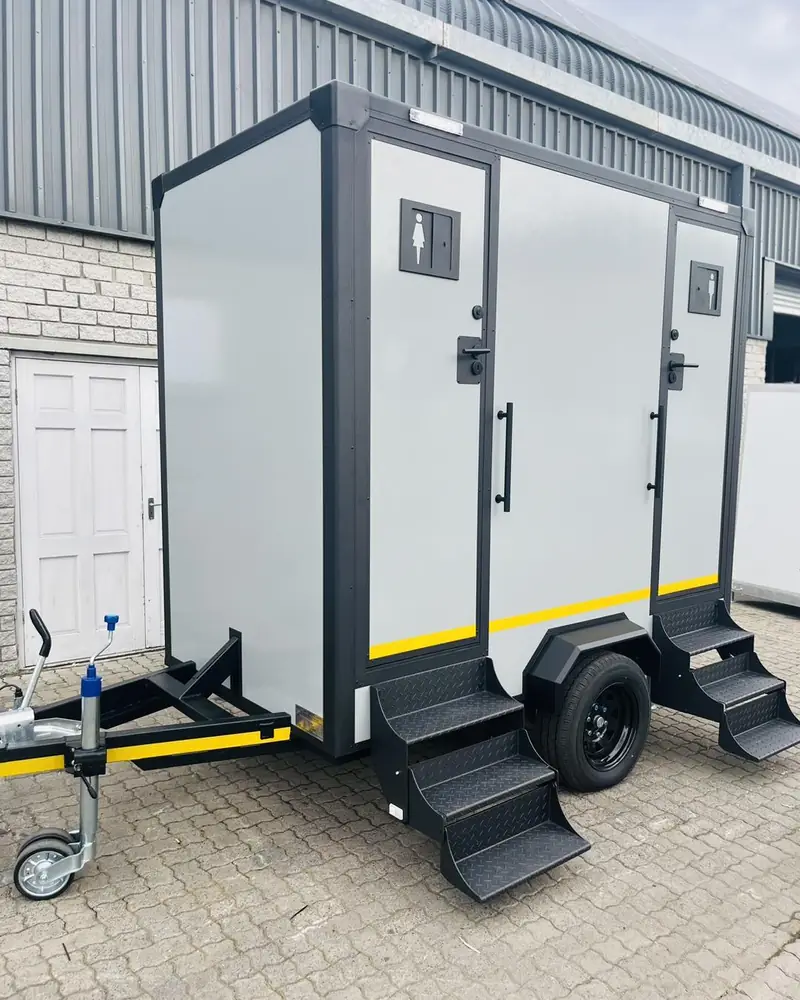 Two-station restroom trailer with steps at each door